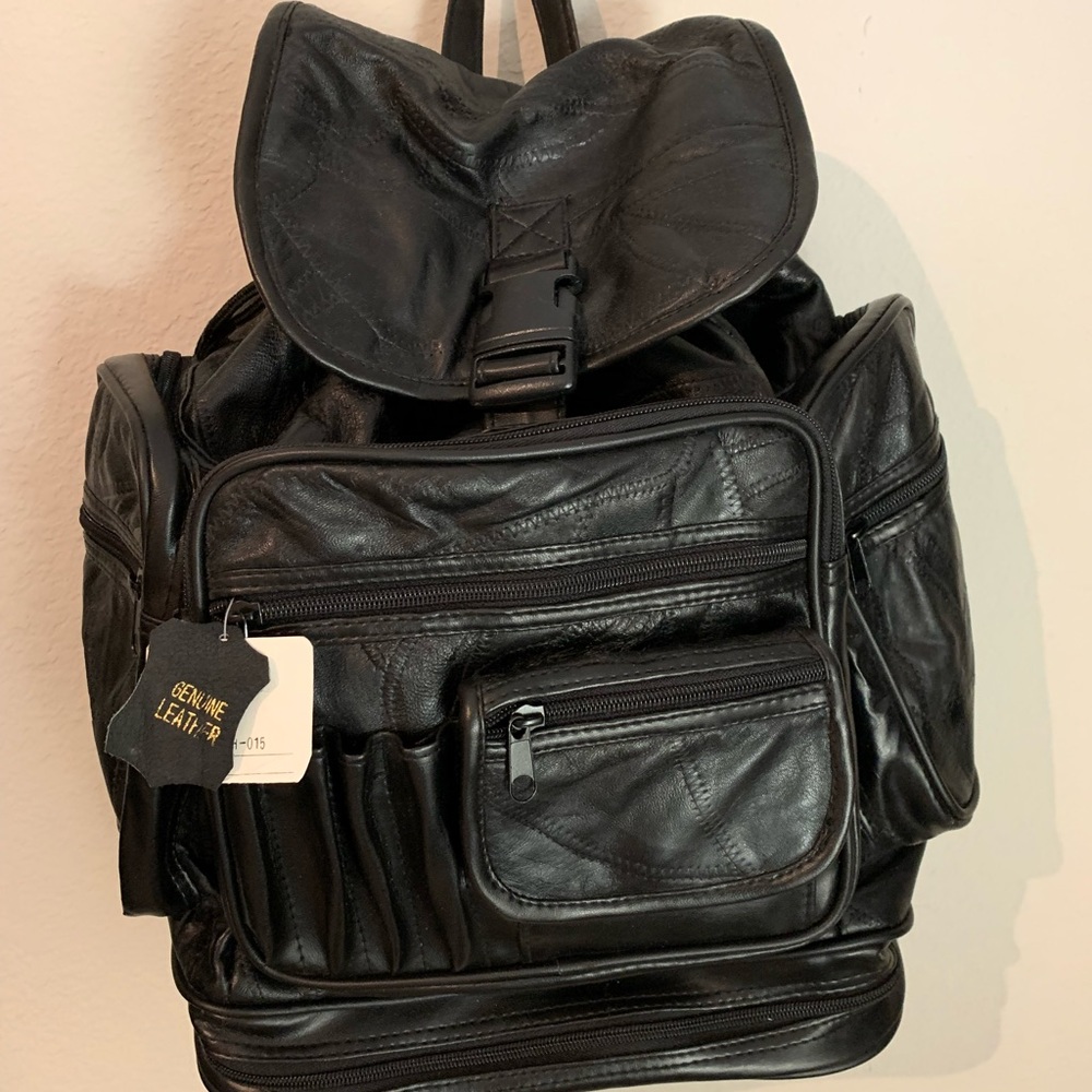 Genuine black leather back pack.  Brand new with tag. Many pockets for storage.